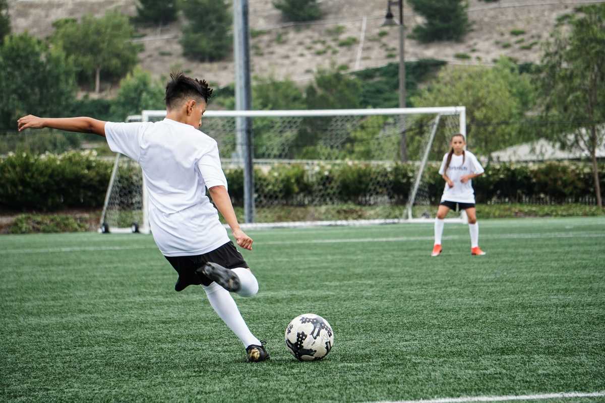 A boy kicks a football